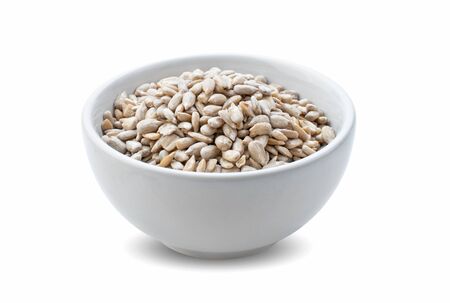 sunflower seeds in bowl isolated on white background.の写真素材