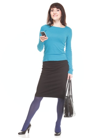 Woman with mobile phone holding a bag  Isolated on whiteの写真素材