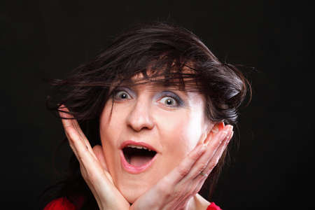 Portrait of young screaming woman with hands upの写真素材