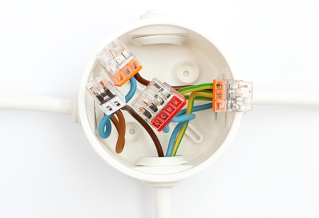 The plastic electrical box on the wall 