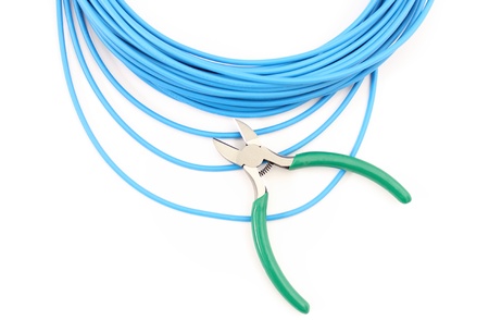 Metal nippers is cutting blue cable on white backgroundの写真素材