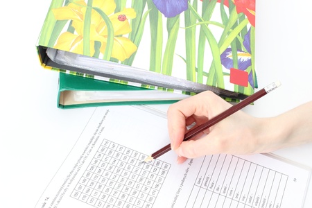 Woman s hand with pencil, documents and file folders
