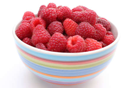 Fresh raspberries in a bowl isolated on a white background