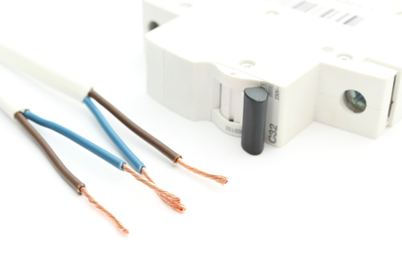 Closeup of electric cable and electric switch. Isolated on white の写真素材