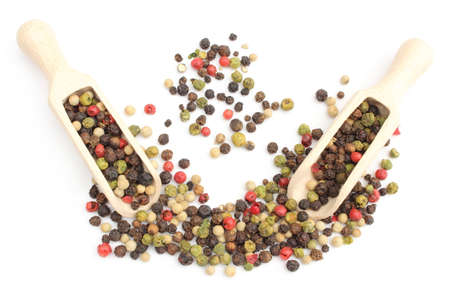 Fresh pepper on wooden spoons and stack of colored pepper  Isolated on white background
