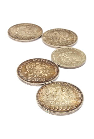 Stack of old polish coins collection lying on white backgroundの写真素材