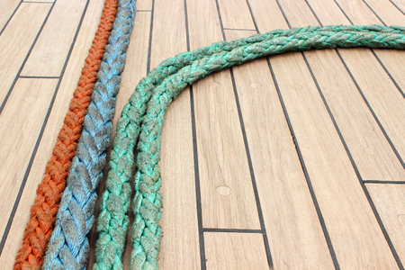 Yachting  Nautical thick ropes, nautical colorful thick cord lying on deck of yacht, rigging details...