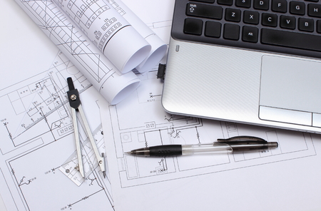 Rolls of electrical diagrams, construction drawings of house, accessories for drawing and laptop,...