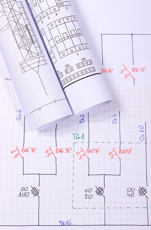 Rolls of electrical diagrams lying on construction drawings, drawings for the projects engineer jobsの写真素材