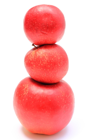 Stack of fresh red apples isolated on white backgroundの写真素材