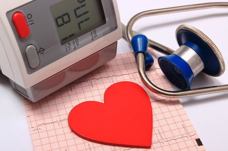 Medical stethoscope, instrument for measuring blood pressure and red heart shape with electrocardiogram graph, ekg heart rhythm, medicine conceptの写真素材
