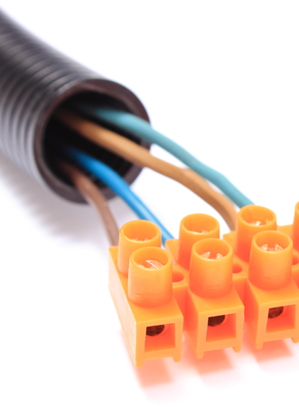 Corrugated plastic pipe and electrical cable with connection cube, component for use in installations. Isolated on white backgroundの写真素材