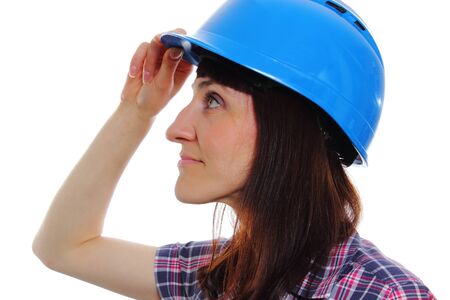 Smiling female construction worker wearing protective blue helmet, industrial worker woman, safety at work. Isolated on white backgroundの写真素材