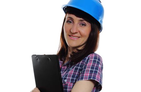 Smiling female construction worker with documents wearing protective blue helmet, industrial worker woman, safety at work. Isolated on white backgroundの写真素材