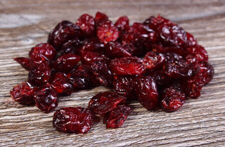 Heap of red cranberries on wooden table, concept for healthy nutrition and eatingの写真素材