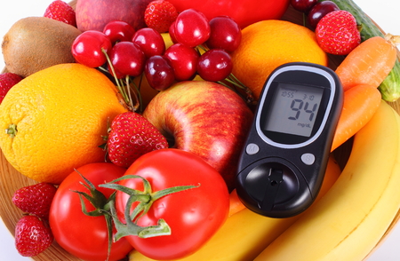 Glucose meter with fresh ripe fruits and vegetables, concept of diabetes, healthy food, nutrition and strengthening immunity. Isolated on white backgroundの写真素材