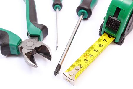 Metal pliers, electrical screwdrivers and tape measure on white background, work tools and accessories for engineering jobsの写真素材