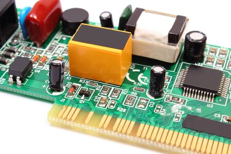 Printed circuit board with electrical components lying on white backgroundの写真素材