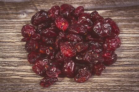 Vintage photo, Heap of red cranberries on wooden table, concept for healthy nutrition and eatingの写真素材
