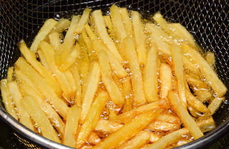 Heap of french fries fried in oil, deep fried, unhealthy and caloric foodの写真素材