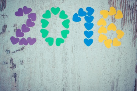 Vintage photo, Happy new year 2016 made of colorful paper hearts on old wooden rustic background and copy space for textの写真素材