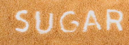 Word sugar written in granulated natural brown cane sugarの写真素材