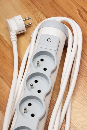 Electrical power strip with switch on-off on wooden floor, electrical extension, power boardの写真素材
