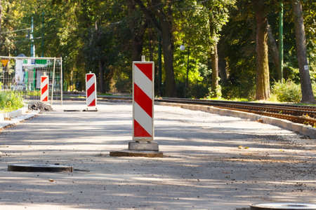 Road sign informing about danger during pavement repair, road construction on city street