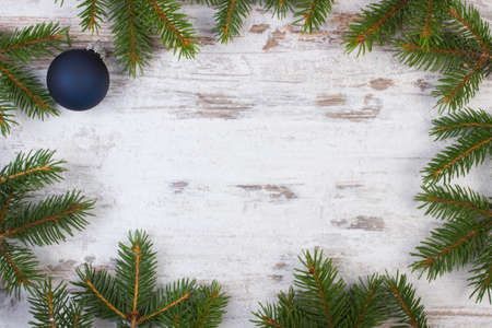 Framework of green spruce branches for Christmas on old wooden plank, copy space for textの写真素材