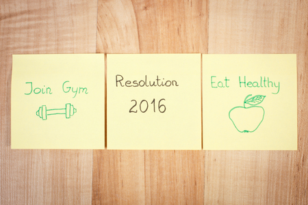 New years resolution written on yellow sheet of paperの写真素材