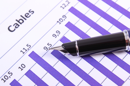 Pen on financial chart, business concept, analysis of sales plan, business report, business work station with paperworkの写真素材