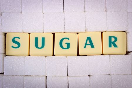 Cubes of sugar with text sugar, ingredient for cooking or bakingの写真素材