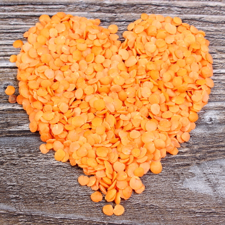 Heart shaped red lentil, concept for healthy eating and nutrition, symbol of loveの写真素材