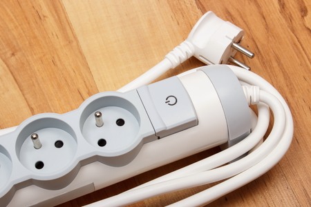 Electrical power strip with switch on-off on wooden floor, electrical extension, power boardの写真素材