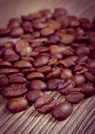 Vintage photo, Coffee beans lying on wooden background, coffee grainsの写真素材