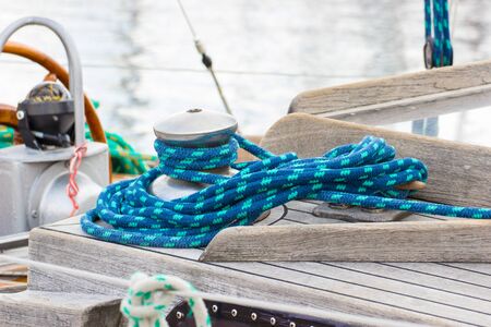 Yachting, wrapped blue rope and bollard on sailboat, details and part of yachtの写真素材
