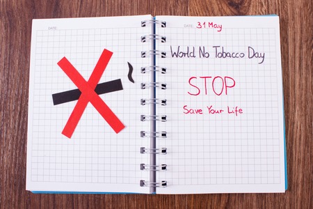 Red no smoking sign made of paper and inscription world no tobacco day written in notebook, symbol of prohibited smoking, healthy lifestyle without cigarettesの写真素材
