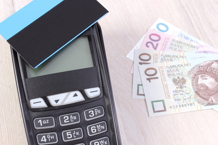 Credit card reader, payment terminal with contactless credit card and polish currency money, choice between cashless or cash paying for shopping or productsの写真素材