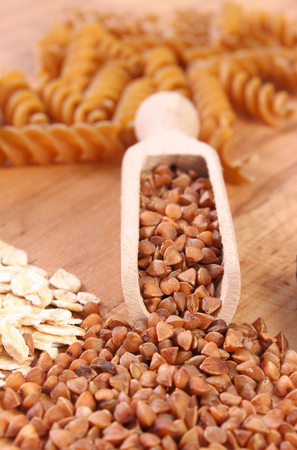 Fresh, natural ingredients and products containing magnesium and dietary fiber, healthy food and nutrition, wholemeal pasta, buckwheat, oatmealの写真素材