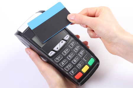 Banking and finance concept, Hand of woman using payment terminal with contactless credit card,...