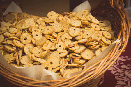 Vintage photo, Fresh baked bagel chips in wicker basket on stall at the bazaarの写真素材