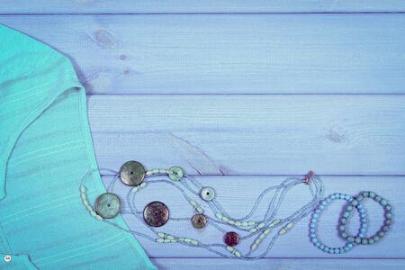 Vintage photo, Clothing for woman and accessories for vacation and summer on boards, shirt, jewelry, copy space for textの写真素材