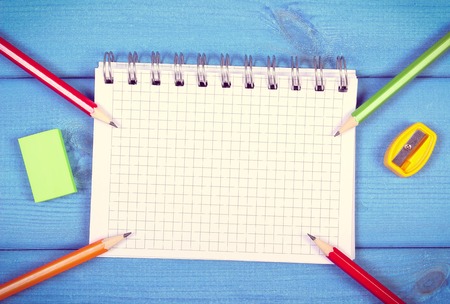 Vintage photo, Colorful crayons, sharpener, eraser and notepad for notes on boards, back to school concept, copy space for text or inscriptionの写真素材