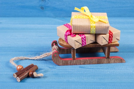 Wooden sled and wrapped gifts with colorful ribbons for Christmas, Valentine, birthday or other...