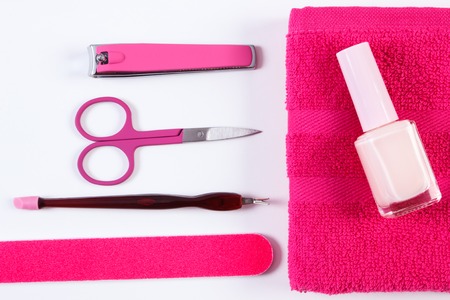 Cosmetics and set of manicure or pedicure tools, nail file, nail polish, scissors, nail clippers, fluffy towel, concept of nail careの写真素材