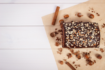 Homemade fresh baked gingerbread or dark cake with cocoa and chocolate on white boards, copy space for text or inscriptionの写真素材