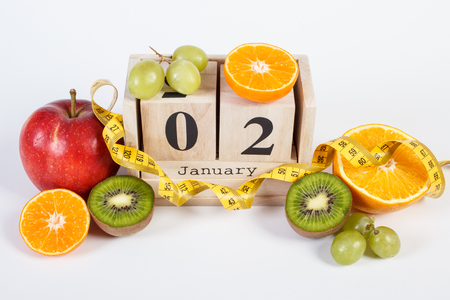 January 1 on cube calendar, fresh fruits and tape measure, new years resolutions of healthy lifestyleの写真素材