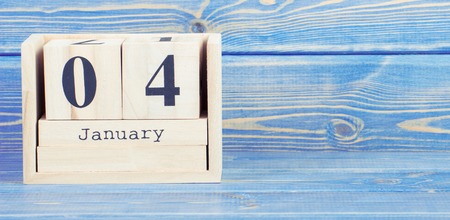 Vintage photo, January 4th. Date of 4 January on wooden cube calendar, copy space for text on boardの写真素材