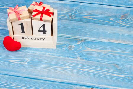 February 14 on cube calendar, wrapped gifts with ribbon and red heart, decoration for Valentines day, copy space for textの写真素材
