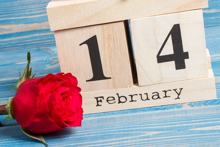 February 14 on cube calendar and red rose flower, decoration for Valentines day